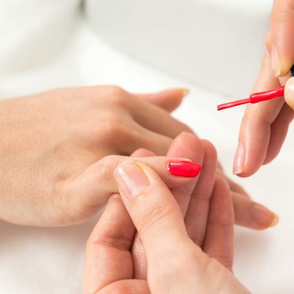 Manicure process in beauty salon close up of female hands